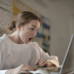 A person reading a negative performance review and responding to negative feedback at work for career growth