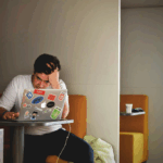 College Student Studying Class Notes to Sell Online as a Side Hustle for Extra Money